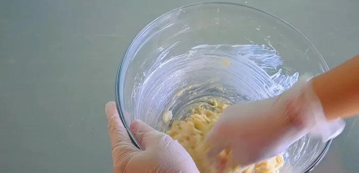 Add softened butter and continue kneading until the dough is smooth and pulls away from the sides of the bowl.