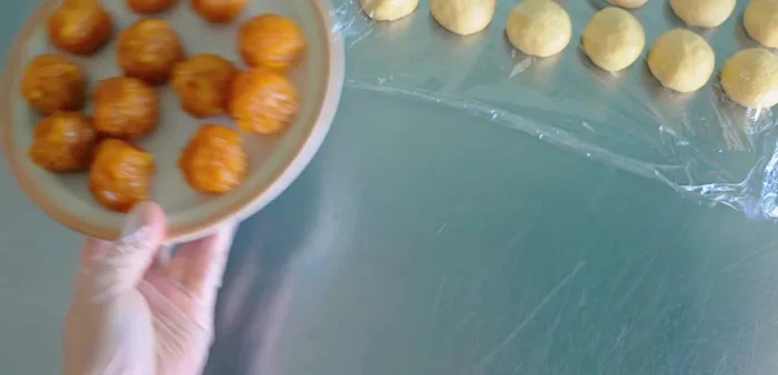 Shape the pineapple filling into balls (approximately 30-35 grams each).