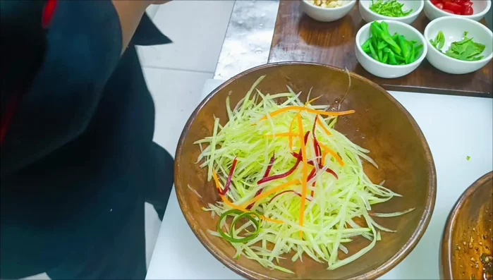 Add carrot, beetroot, beans, basil leaves, spring onion, and cherry tomatoes to the bowl.