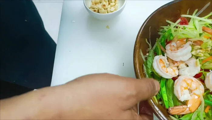 Add the peanuts to the bowl.