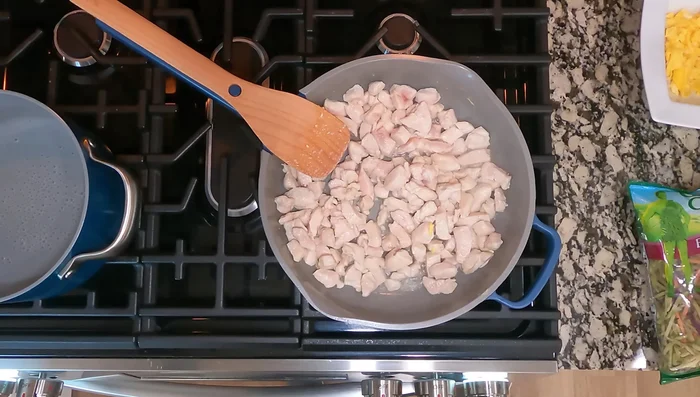 Add the remaining vegetables (carrots, cabbage, red pepper, green onions) to the skillet.