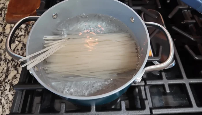 Add cooked rice noodles.