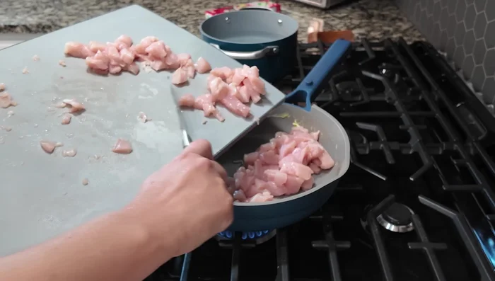Add chicken to the skillet and sauté for 2 minutes, seasoning with garlic powder, onion powder, and salt.