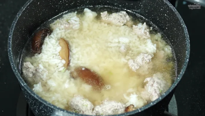 Simmer until the rice is soft and the congee has thickened.