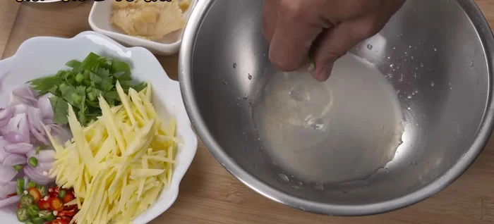 Prepare the mango salad: Combine diced mango, lemon juice, fish sauce, palm sugar, shallots, and chilies. Mix well.