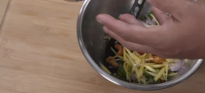 Add fried cashew nuts (or peanuts) to the mango salad.