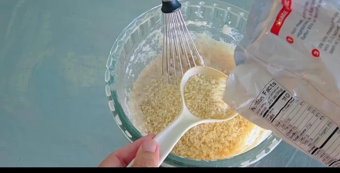 Gradually add breadcrumbs and mix well.
