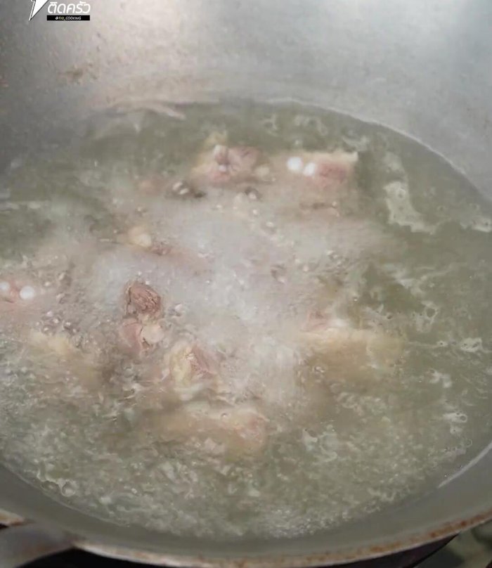 Add the curry paste to the pot with the tender pork ribs.