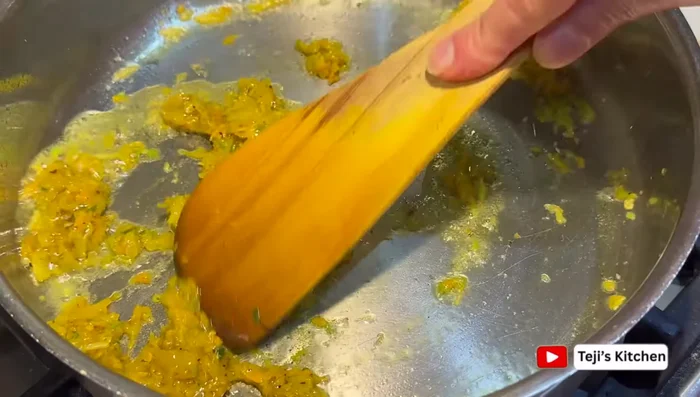 Heat oil in a pan. Add the curry paste and sauté until fragrant. Add coconut milk and water. Simmer.