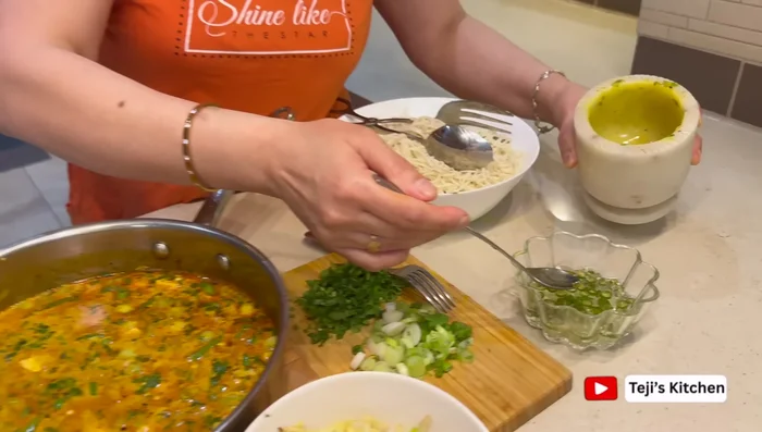 Prepare a simple dipping sauce with vinegar, green chilies, garlic, and salt.