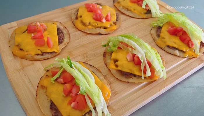 Assemble the tacos: Place the cooked pork sheet in a tortilla. Add lettuce, fried onions, tomatoes, and taco sauce.