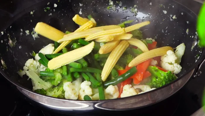 Add mushrooms and corn after a few minutes.