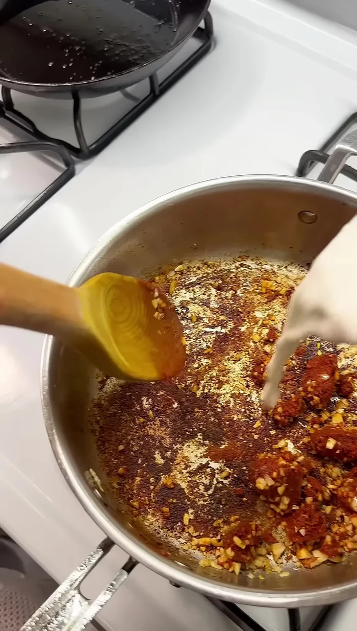 Add Thai red curry paste.