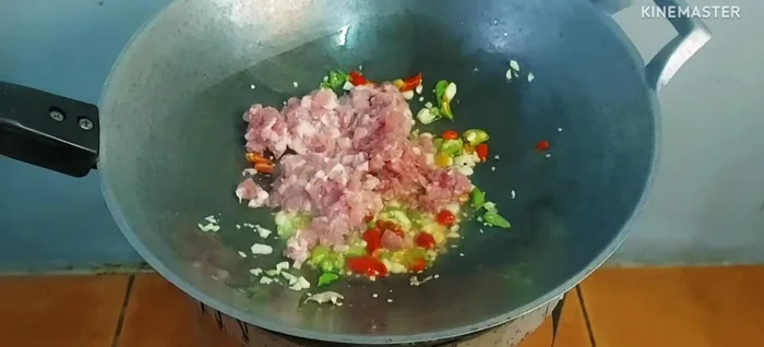 Add minced pork and stir-fry until cooked.
