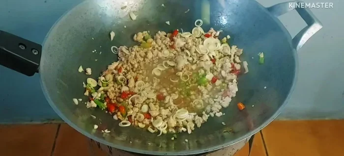 Add sliced lemongrass and kaffir lime leaves. Stir-fry until well combined.