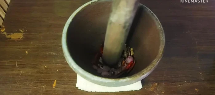 Pound the roasted ingredients into a fine paste. Add shrimp paste and pound together.