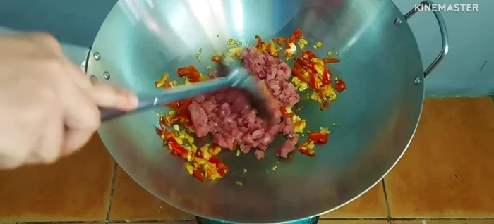 Add the minced pork and stir-fry until cooked through.