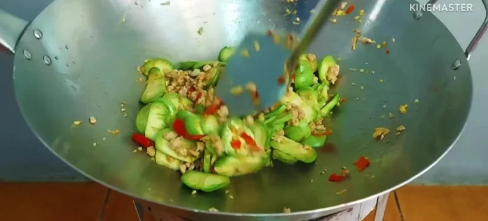 Continue stir-frying until the eggplant is cooked.