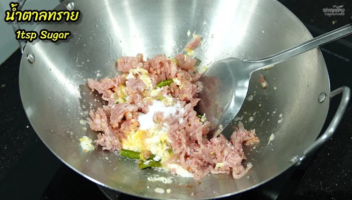 Add sugar, seasoning powder, oyster sauce, fish sauce, and pepper. Stir well.