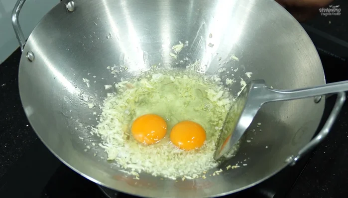 Add eggs and scramble them into small pieces.