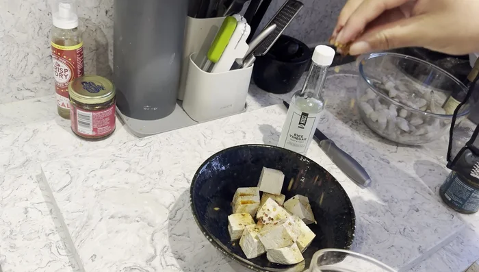 Prepare the tofu: Cut into cubes, marinate with soy sauce and crushed chilies.