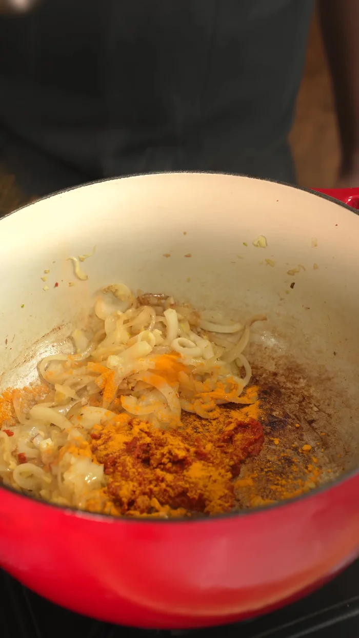Add red curry paste, turmeric, red chili flakes, salt, onion powder, black pepper, and brown sugar.