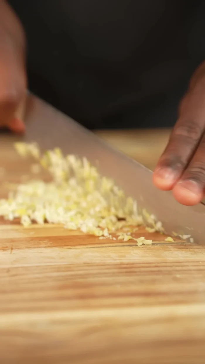Chop garlic and ginger. Add to a pot and drizzle with oil. Cook until fragrant.