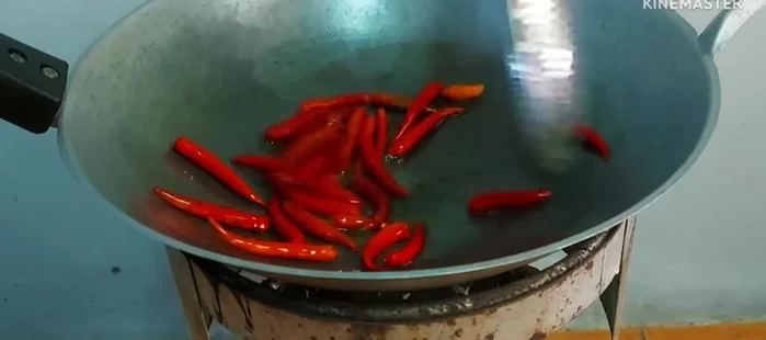 Fry the dried chilies until fragrant and slightly softened, being careful not to burn them.