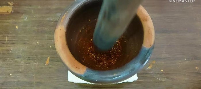 Pound the fried chilies to a paste.