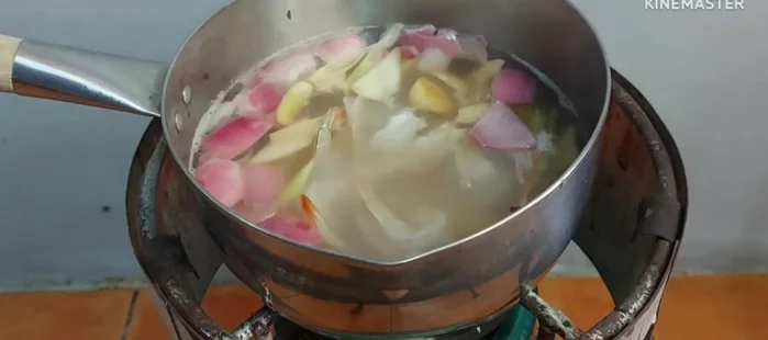 Add the fresh shrimp and kaffir lime leaves to the boiling broth.