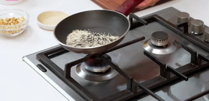 Lightly toast sesame seeds (both white and black) until they start to crackle. Set aside to cool.