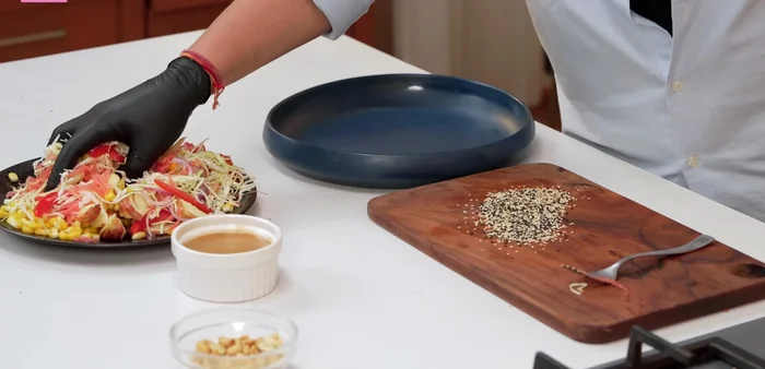 Add the dressing to the vegetables. Gently mix the vegetables and dressing. Add roasted peanuts and sesame seeds, toss gently and serve.