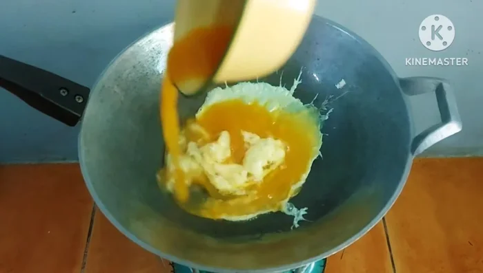 Heat oil in a frying pan. Pour in the egg mixture and let it set slightly.