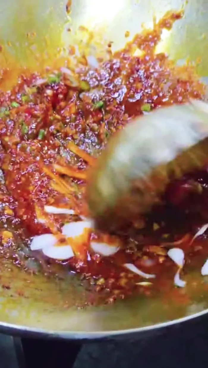 Add coriander and spring onion to the sauce.