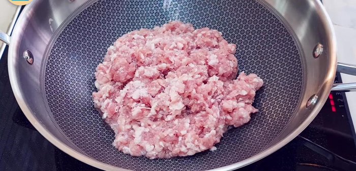 Heat the pan and add the minced pork. Add salt, fish sauce, and kaffir lime leaves. Stir until the pork changes color to gray (about 2.5 minutes). Break up any clumps.