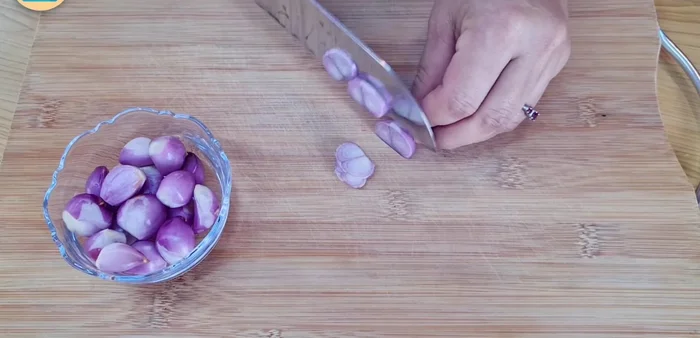 Leave the marinated pork aside. Slice shallots thinly and add to a bowl. Cut basil and mint leaves into smaller pieces and add to the bowl with shallots. Set aside.