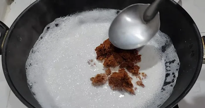 Add the curry paste and mix well with the coconut milk. Reduce heat to low.