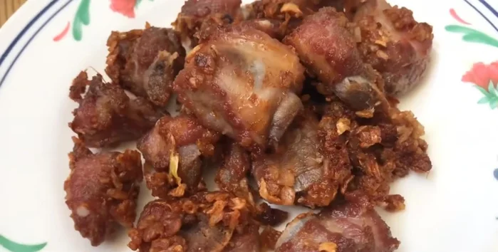 Serve the fried pork ribs, rice, and garlic.