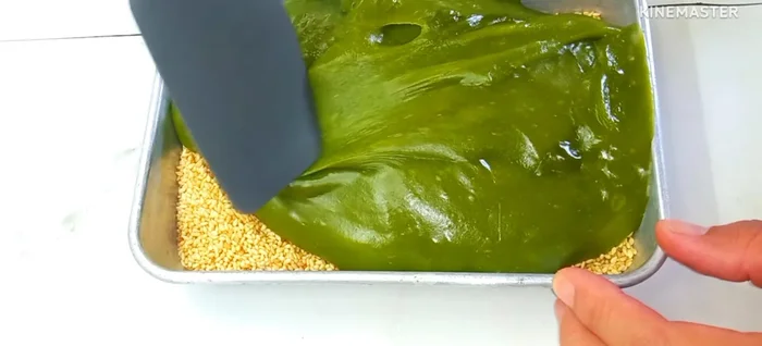 Smooth the top surface with a spatula. Sprinkle the remaining sesame seeds to prevent sticking.