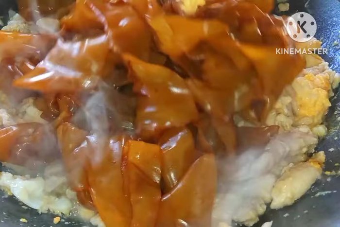 Add the noodles and stir-fry to combine with the chicken and eggs.