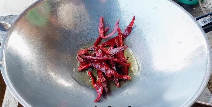Fry the dried chilies in vegetable oil until dry and crispy. Set aside.