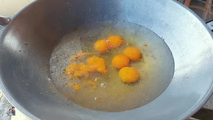 Crack 6 eggs into a cup. Add light soy sauce, chili powder, and Thai chili powder. Whisk well.