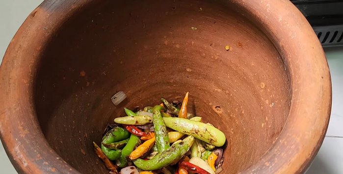 Pound the roasted shallots, garlic, and chili in a mortar and pestle until desired consistency is reached.