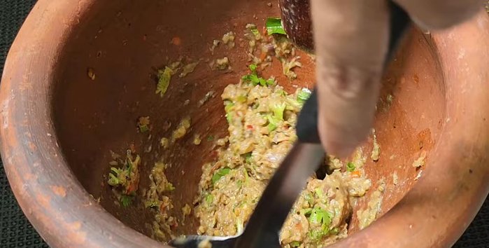 Gently pound the mixture again and taste to adjust the seasoning.