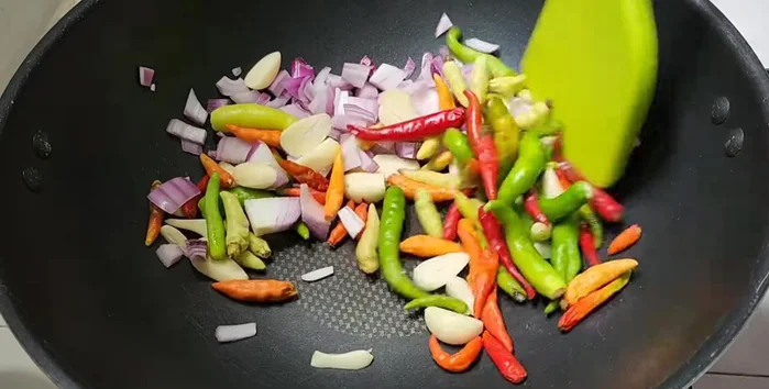 Roast shallots, garlic, and chili until cooked. The amount of chili can be adjusted to your spice preference.