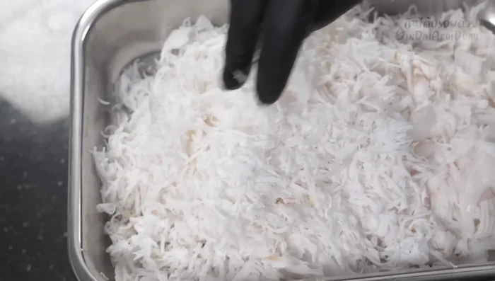 Separate the grated coconut into two parts: thicker, harder pieces and finer, younger coconut.