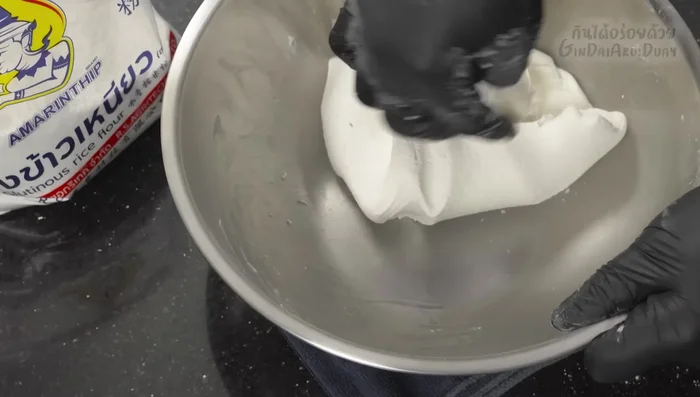 Roll out small portions of dough into thin circles, place a filling ball in the center, and wrap tightly, sealing all edges to prevent water from entering during boiling.