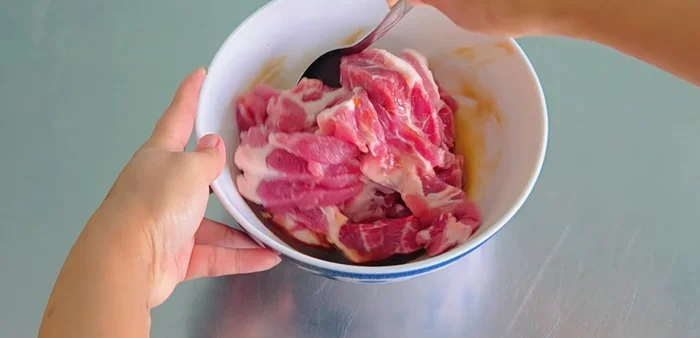 Add the pork to the mixed seasoning and toss to coat.