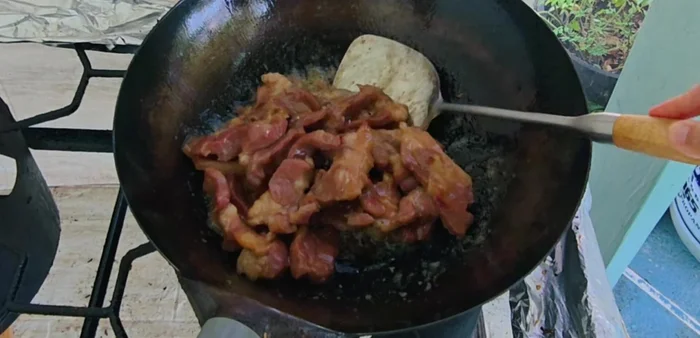 Continue stir-frying until pork is cooked and darkens in color. The sauce will gradually seep into the meat.