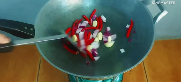 Roast the chilis, shallots, and garlic until cooked.